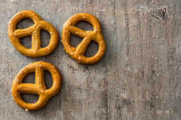 Salted pretzels on wooden background