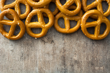 Salted pretzels on wooden background