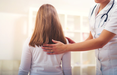 Chiropractor doing adjustment on female patient