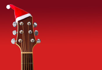 Red Christmas hat on guitar with red background, Merry Christmas song