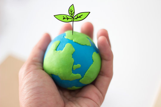 globe on hand with plant, safe the world , ecology concept
