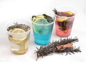 three healthy herbal tea on a white background with a sprig of rosemary and cinnamon stick. Healthy food and drink abstract