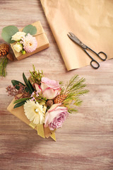 Handcrafted gift boxes with flowers on wooden table