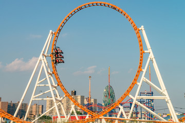 Roller coaster and buildings cityscape  on the Brighton Beach. It is known for its high population of Russian-speaking immigrants, and as a summer destination for New York City residents.