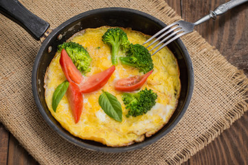Frittata with herbs, tomatoes and feta cheese. Top view. Close-up