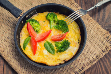 Frittata with herbs, tomatoes and feta cheese. Top view. Close-up