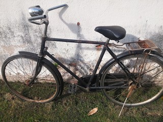 Fototapeta na wymiar The vintage bicycle on a street 