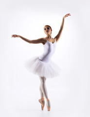 Obraz premium Young beautiful ballet dancer on a white background
