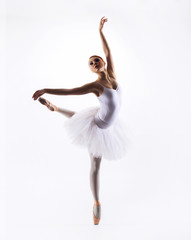 Fototapeta na wymiar Young beautiful ballet dancer on a white background