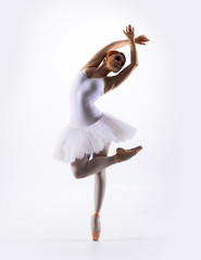 Young beautiful ballet dancer on a white background