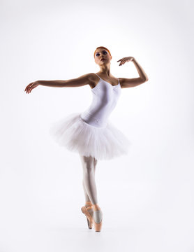 Young beautiful ballet dancer on a white background