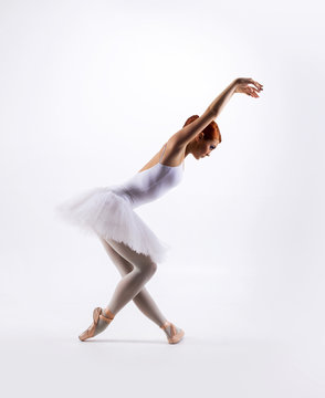 Young beautiful ballet dancer on a white background