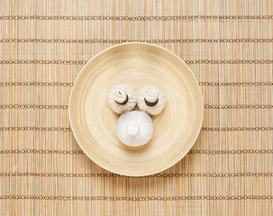 Massage bundles on a plate on a bamboo mat