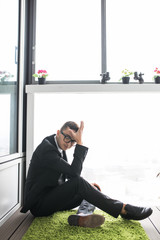 Stressed business man about failure in rest room