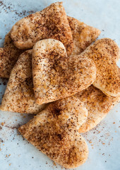 Valentines day heart shaped cookies with sugar and cinnamon - festive dessert idea for holidays, closeup, top view