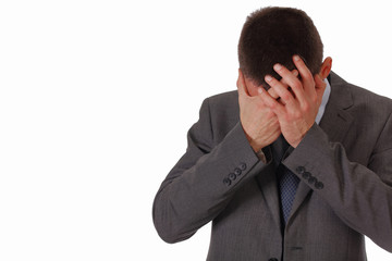Stressed business man suffering from a headache isolated on white background