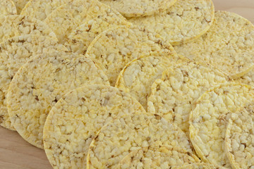 Close up of popped corn cakes on wooden table