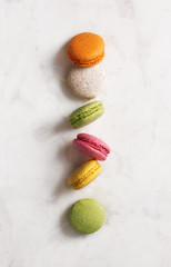 Macarons flat lay on marble texture background. Top view