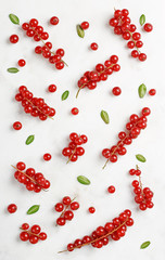 Currants pattern flat lay on marble texture background. Top view