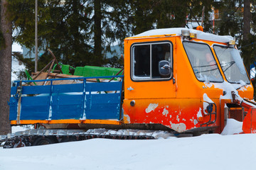 Snowcat machine is covered with snow.