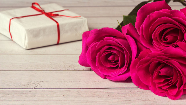 Romantic composition with rose flowers and gift St. Valentines Day background