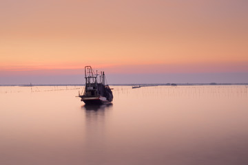 Fototapeta na wymiar Fishing boat and sunset