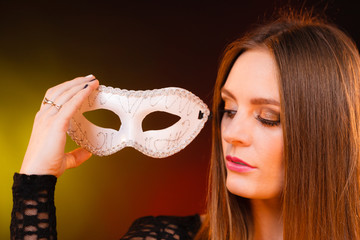 Sensual lady holding carnival mask.