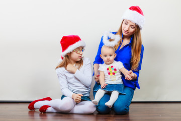 Mother and daughters in christmas outfit