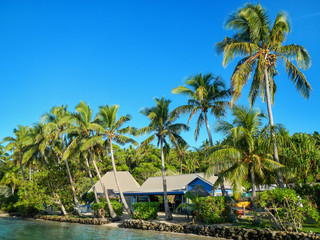 Fototapeta na wymiar Resort surrounded by leaning palm trees on Nananu-i-Ra island, F