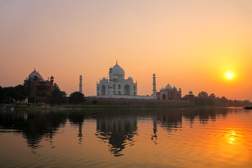 Taj Mahal reflected in Yamuna river at sunset in Agra, India