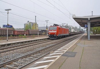 Fototapeta premium freight train passing through a smal train station in Lahr, Baden Germany