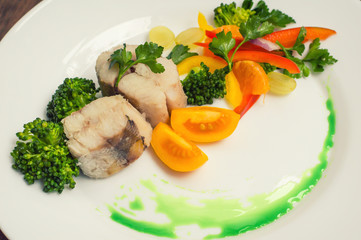 Boiled seabass with steamed vegetables - totally healthy meal. Close-up