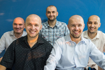 Group portrait of young bald men