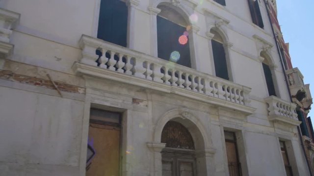 Bright sun shining in blue sky over old Baroque buildings, travel to Venice