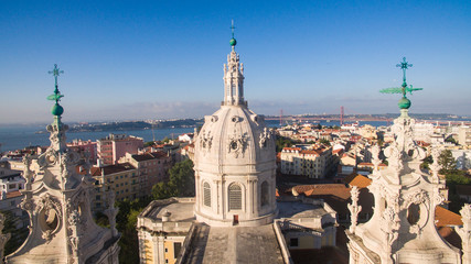 Fototapeta na wymiar Dome of the Estrela Basilica on a background Lisbon at morning aerial view