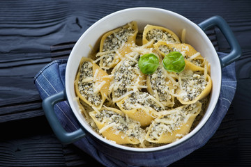 Casserole with cheese and spinach stuffed conchiglioni pasta