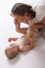 mom play change baby diaper