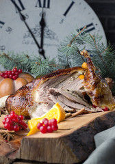 Total roast duck chopped into pieces, festive table with ukrashe