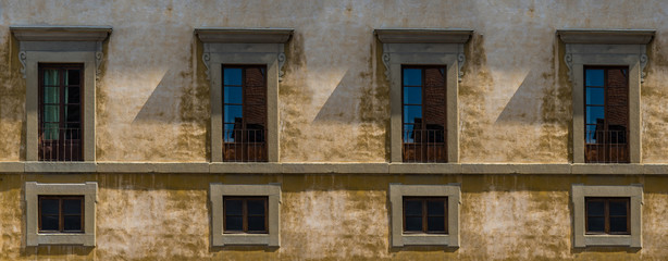 Tuscan architecture building facade with windows in Florence