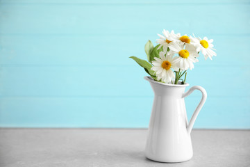 Vase with bouquet of beautiful flowers on color background
