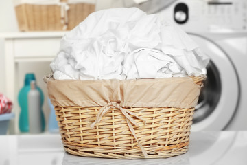 Clothes in wicker basket at laundry