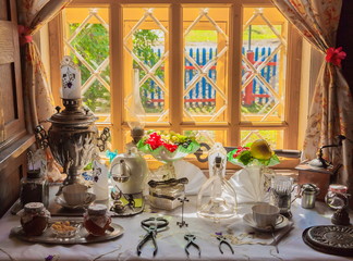 Table with antique tea utensils, with the samovar and tea accessories
