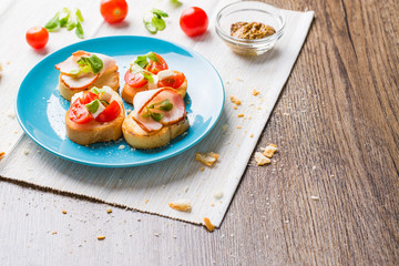 Bruschetta with tomato, cheese and bacon