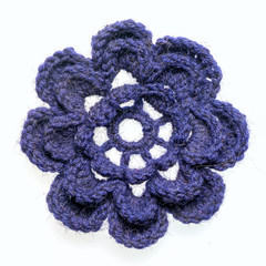 homemade crocheted blue flower isolated on white background