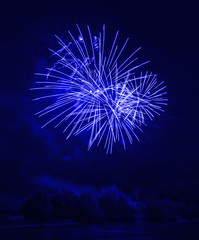 Awesome blue fireworks at night on the river 