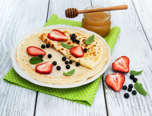 Fototapeta na wymiar crepes with strawberries and blueberries