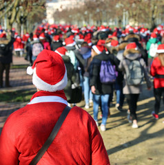 many people dressed as Santa Claus in the city