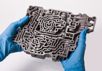 Repair automatic transmission specialist hydraulic unit holds in his hands. We study for repairs.
