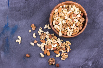 Walnuts, almonds,pine nuts,hazelnuts,cashews in a wooden bowl