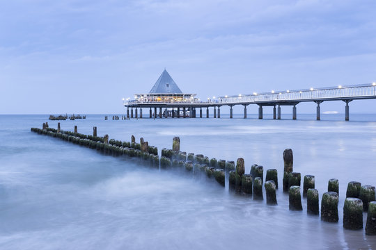 Germany, Usedom, Heringsdorf, remains of the old and new pier in the evening